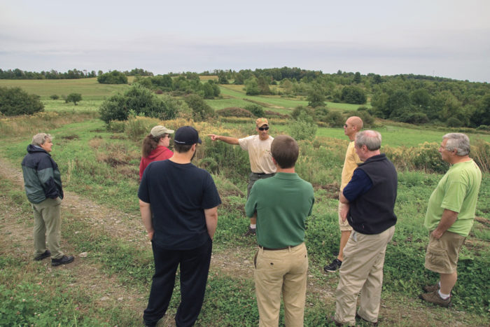 John Lemondes leading a farm tour for a group of farmer veterans. (Photo © James Bemus.)