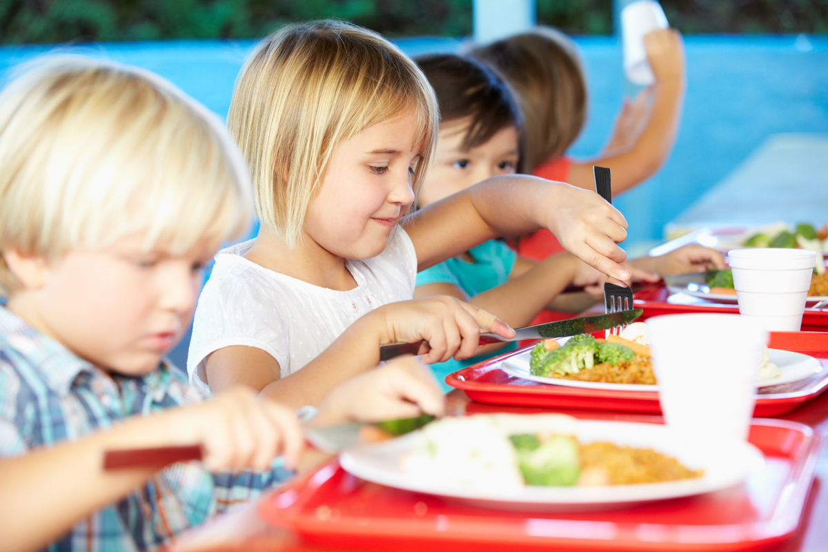kids eating school lunch in the cafeteria