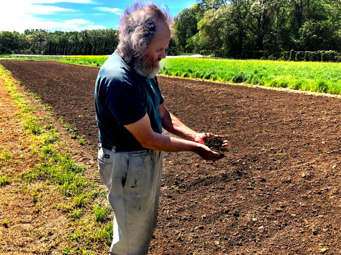 Heinz Thomet holding the soil at Next Step Produce in Maryland