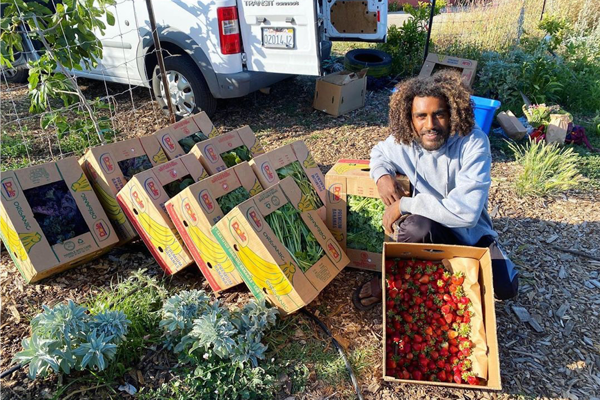 Jamil Burns of Raised Roots Farm in Oakland, shows off some of his produce destined for mutual aid for protesters seeking Black liberation.