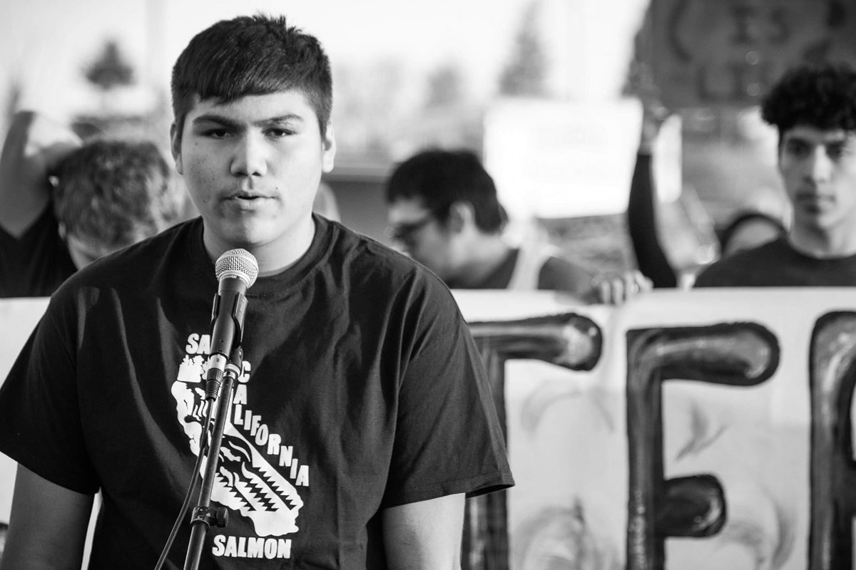 A member of the Hoopa Valley High School Water Protectors Club speaks at a 2020 rally to shut down the Delta Tunnels Project. (Photo courtesy of Wingspan Media)