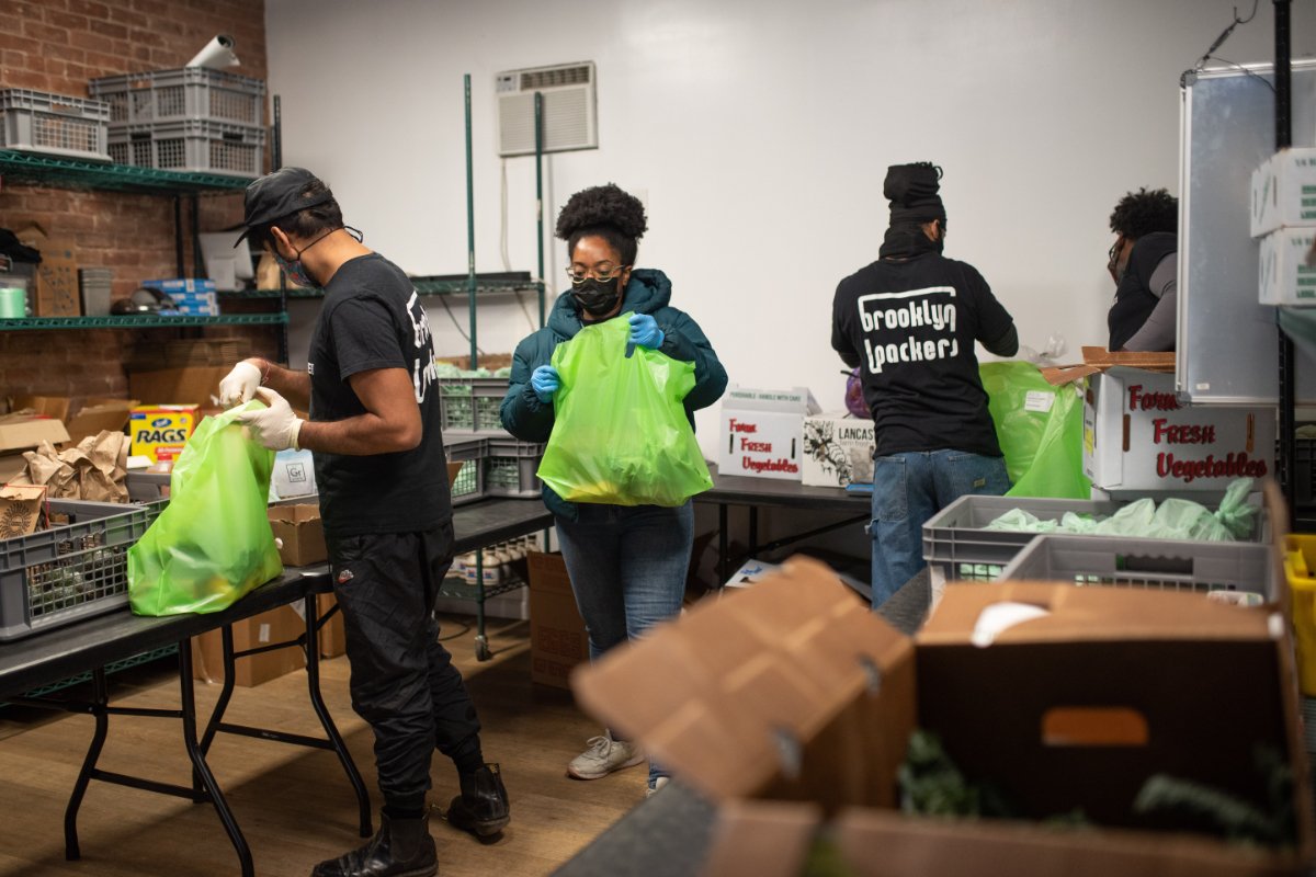 Brooklyn Packers working to fill food delivery bags to co-op members. Photo credit: Mark Davis